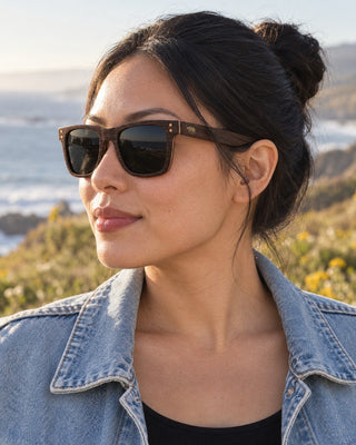 Half Moon Bay polarized sunglasses worn by a woman on a coastal bluff in Half Moon Bay