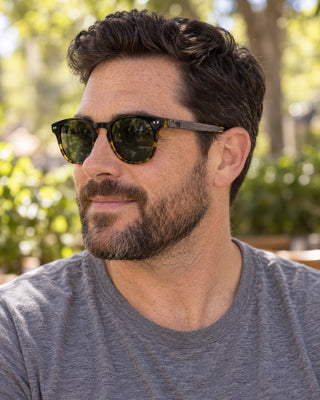 Palo Alto polarized sunglasses worn by a man at an outdoor cafe in Palo Alto
