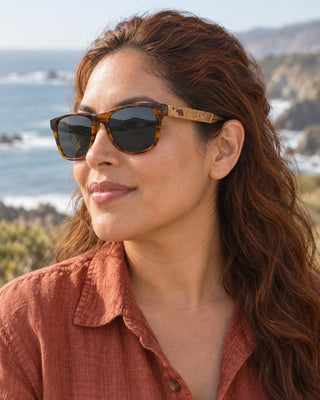 San Simeon polarized sunglasses worn by a woman on the coastal bluffs at San Simeon